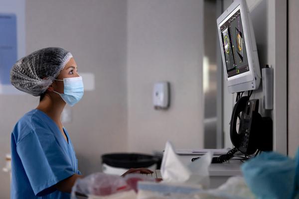 Health care professional looking at display in a lab setting